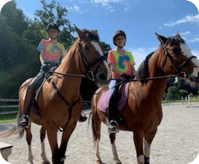 Two Girls Horseback Riding